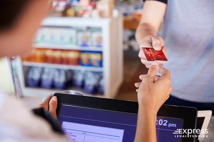 Handing Credit Card to Cashier