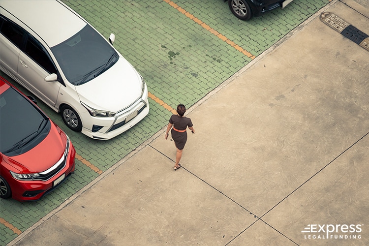 Person Walking in a Parking Lot