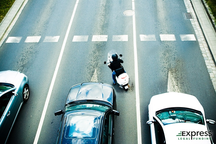 Motorcyclist Overtaking Vehicles at an Intersection