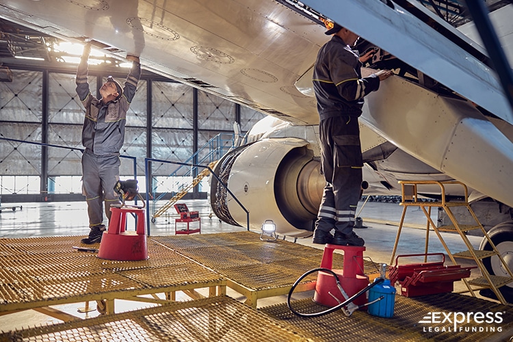 Engineers Maintaining a Plane