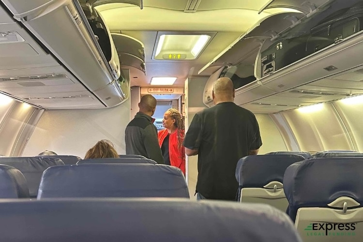 Commercial airline passengers standing and flight attendant